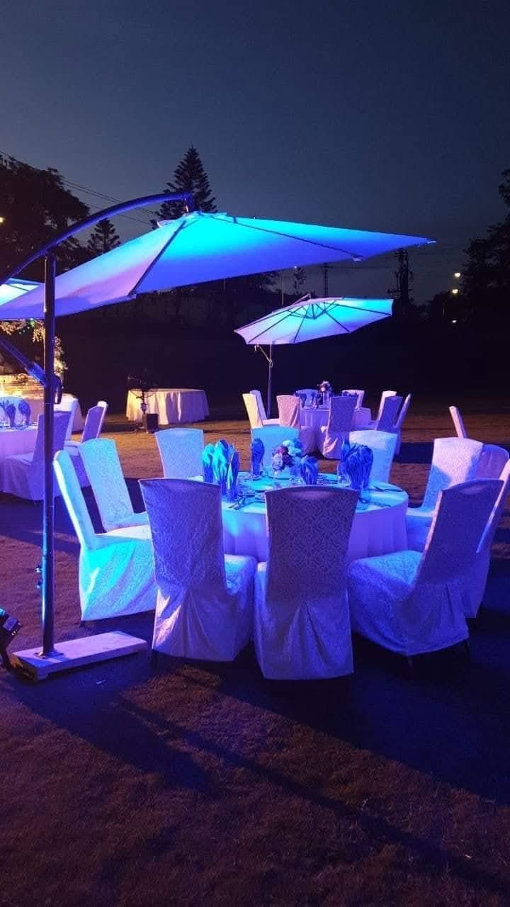Oasis umbrella dining setup at night